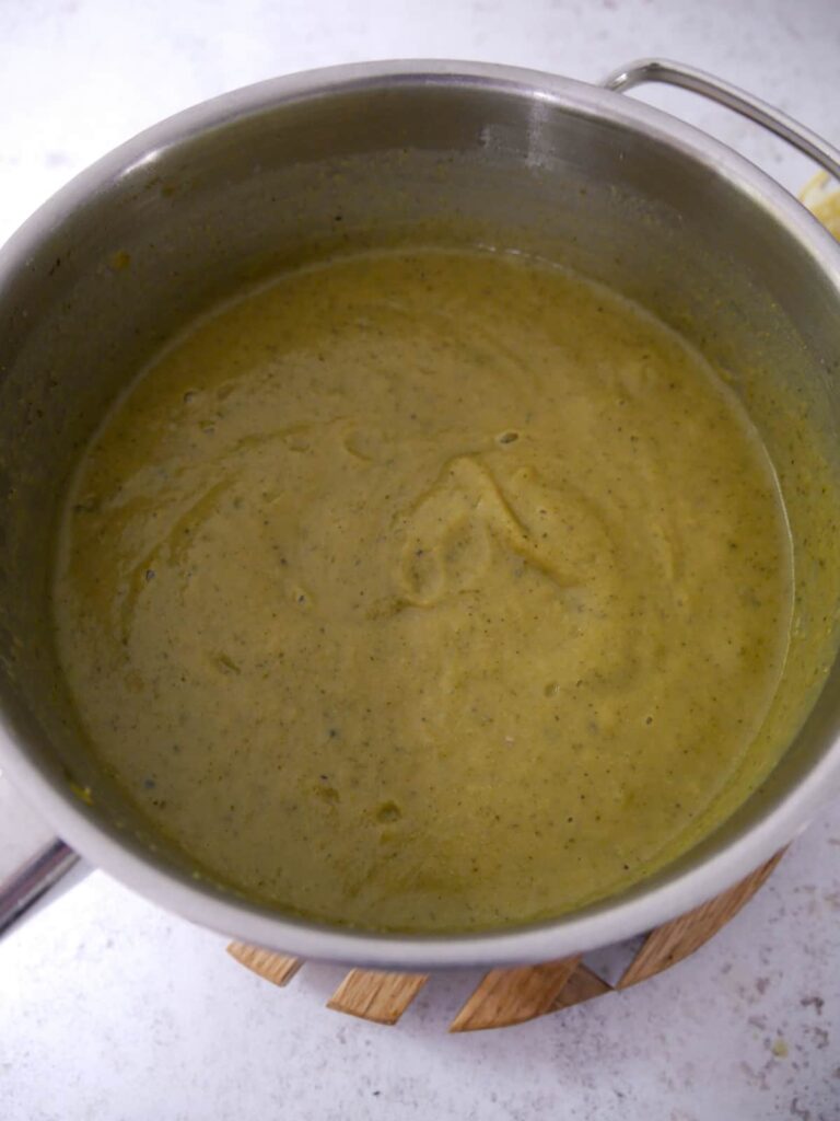 A saucepan of blended broccoli and courgette soup.