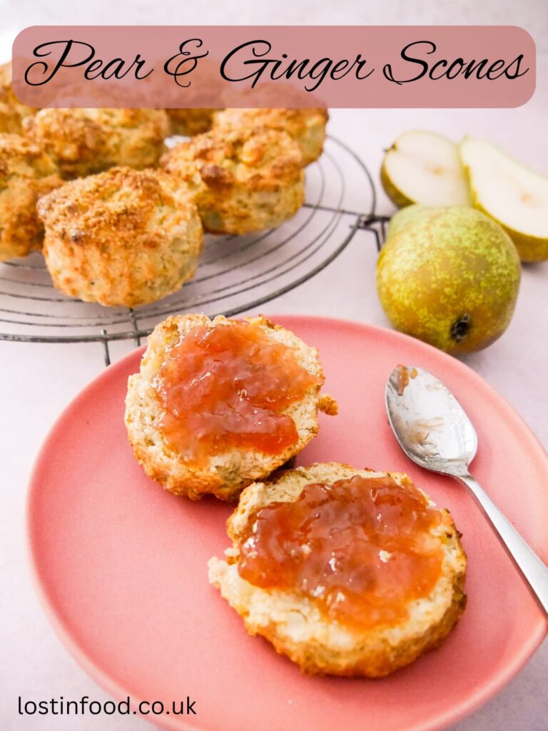 Pinnable image with recipe title and a pink plate with a pear and ginger scone topped with jam, and a wire rack of scones set alongside.