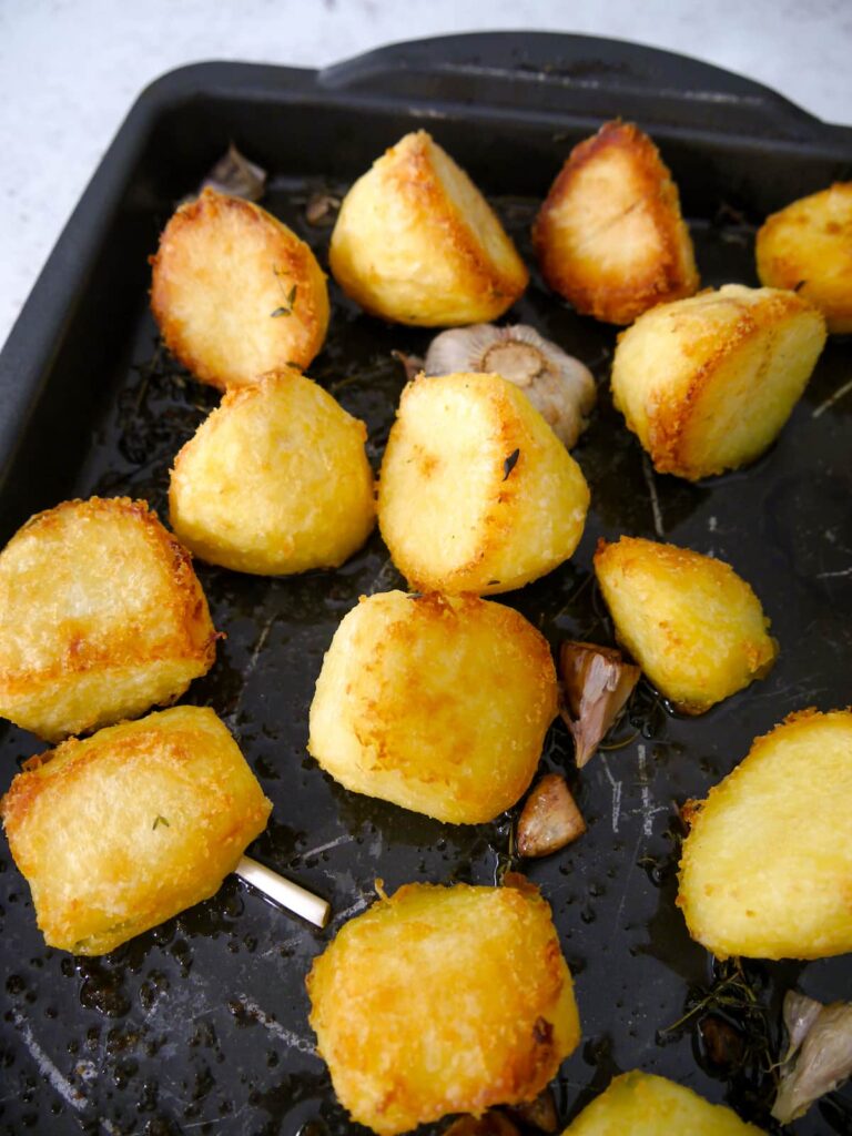 A roasting dish filled with roasted potatoes.