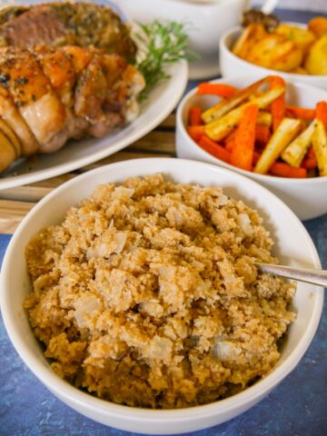 A bowl of Scottish oatmeal stuffing with roasted vegetables and turkey set alongside.