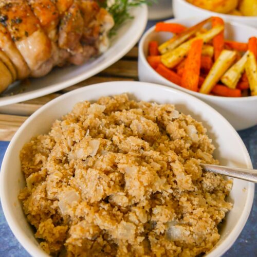 A bowl of Scottish oatmeal stuffing with roasted vegetables and turkey set alongside.