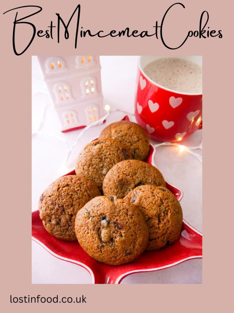 Pinnable image with recipe title and a plate topped with mincemeat cookies with a mug of hot chocolate set alongside.