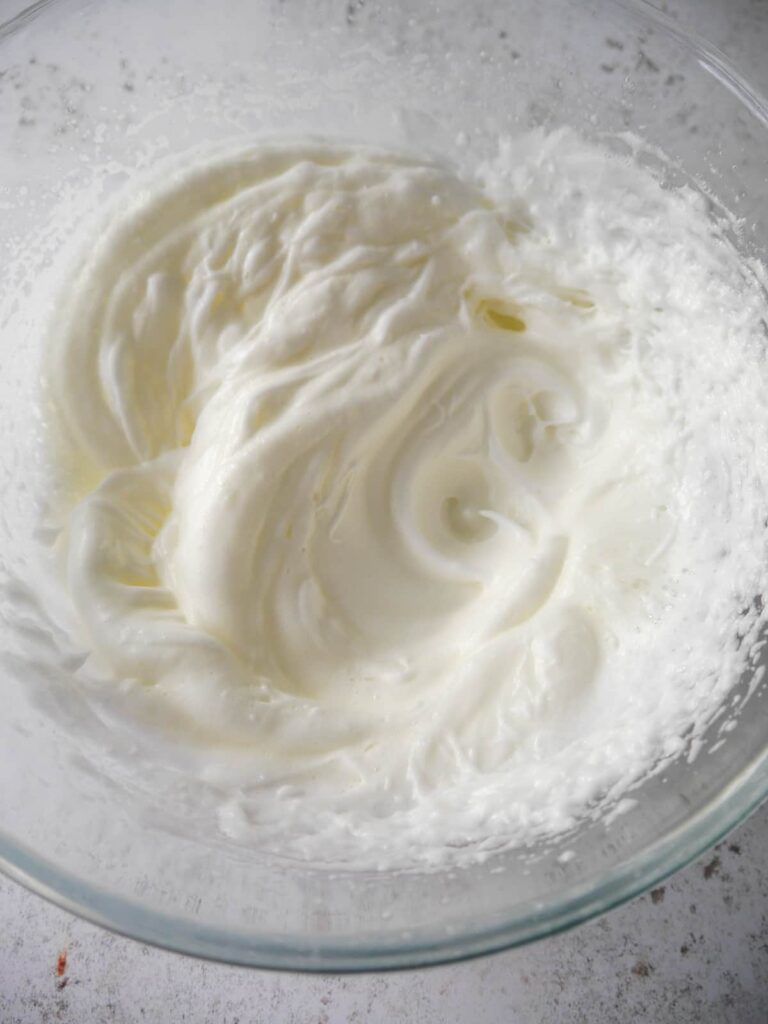 A large bowl of whisked egg whites.