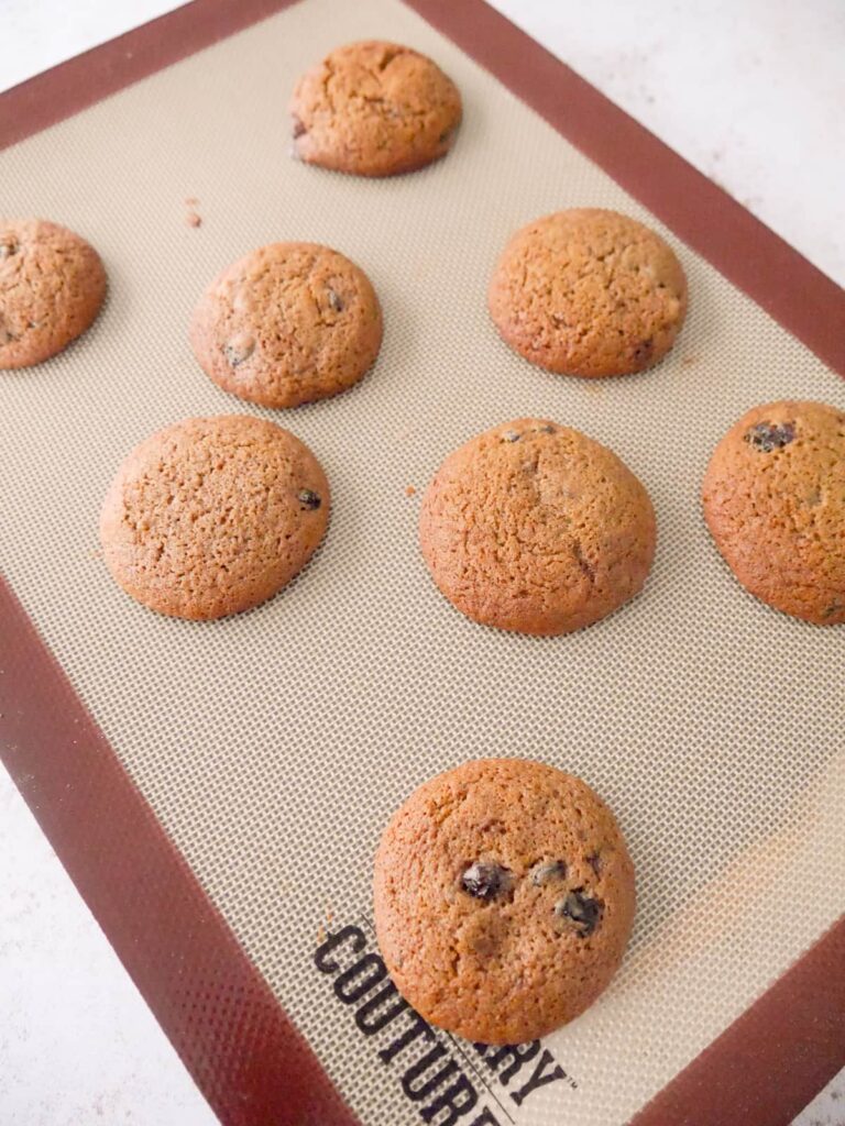 Baked mincemeat cookies on a baking sheet lined with a silicone mat.