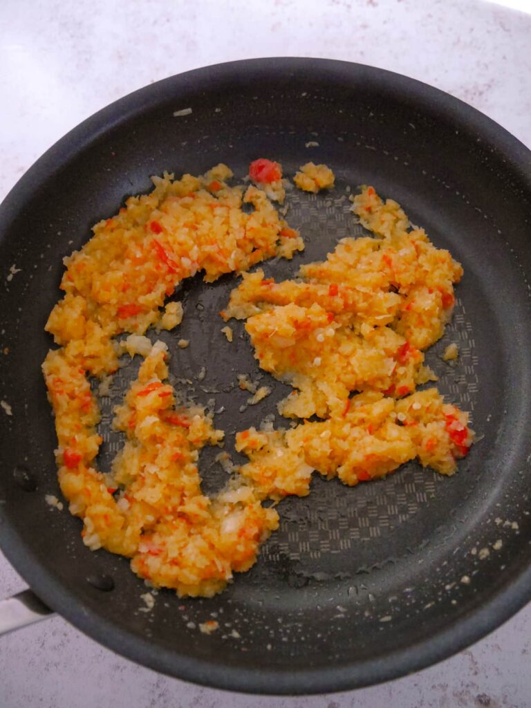 Onion, garlic, ginger and chilli paste added to a large frying pan.