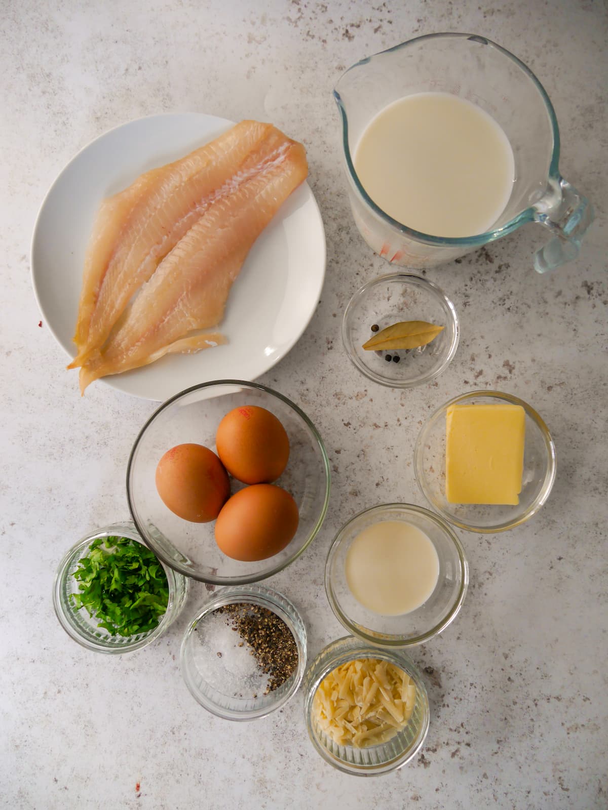 Ingredients for omelette Arnold Bennett set out in individual bowls.