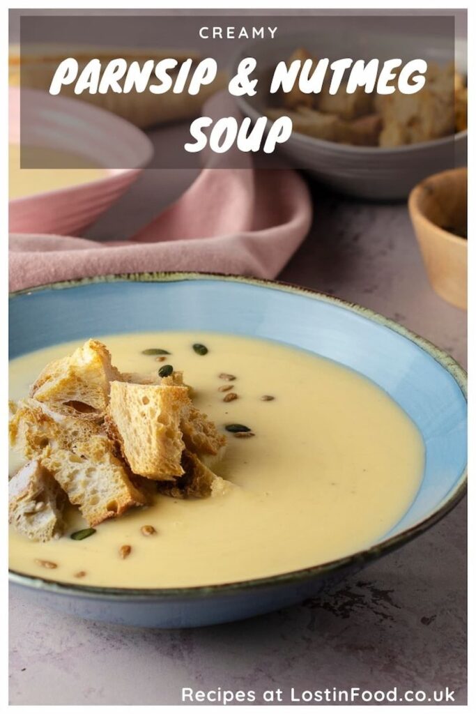 Pinnable image with recipe title and a bowl of creamy parsnip soup garnished with croutons and toasted pumpkin and sunflower seeds.