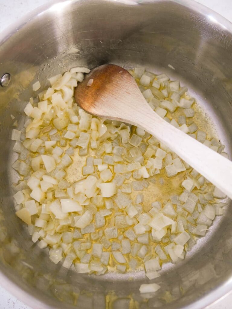 A saucepan of chopped onions sauteed in butter.