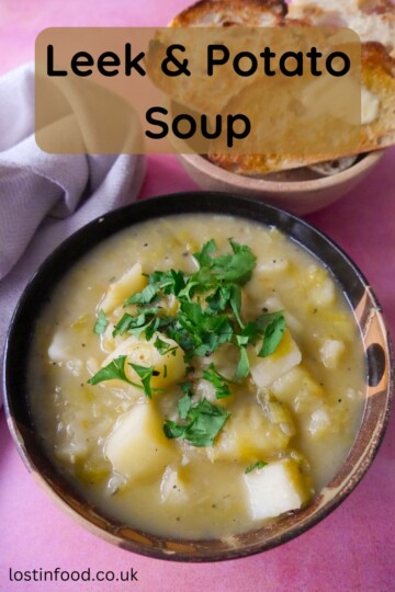 Pinnable image with recipe title and a bowl of rustic leek and potato soup topped with a garnish of chopped parsley, with a side of buttered toast.