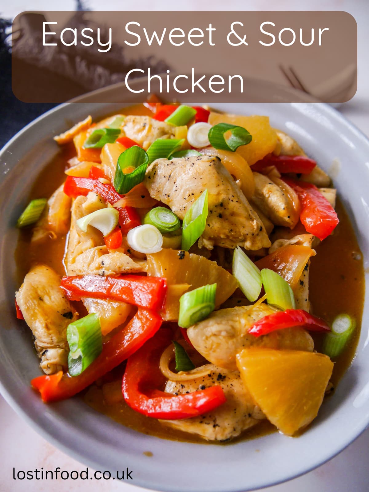 Pinnable image with recipe title and a bowl of sweet and sour chicken with stir-fried vegetables.