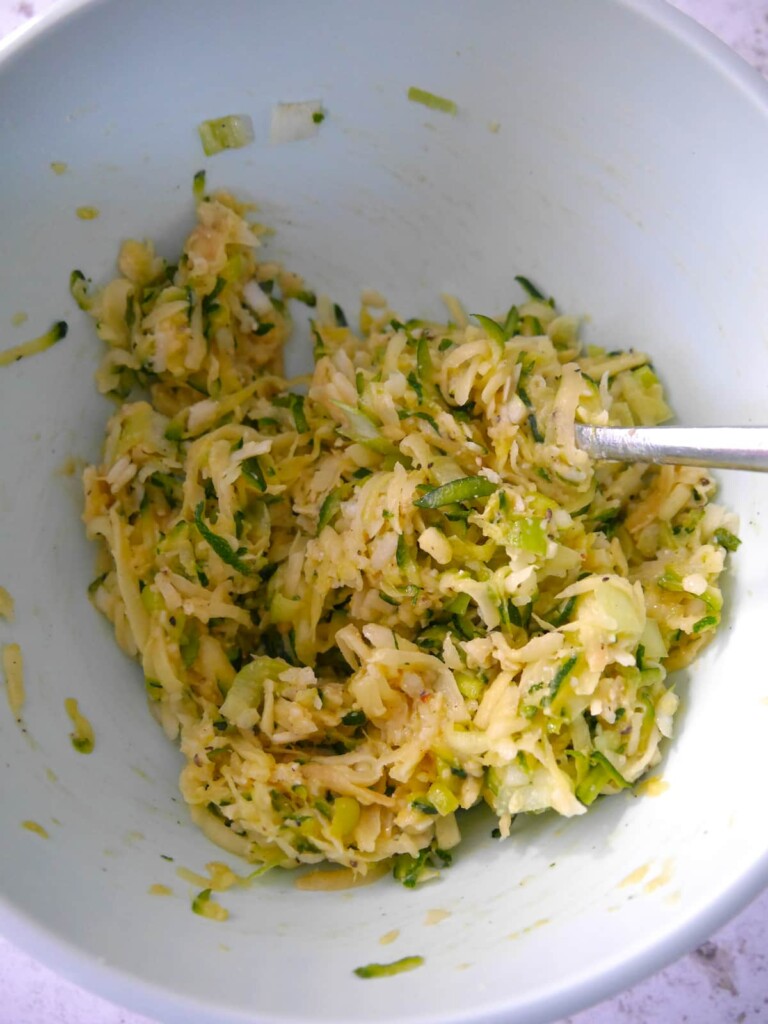 A bowl of combined courgette fritter mixture.