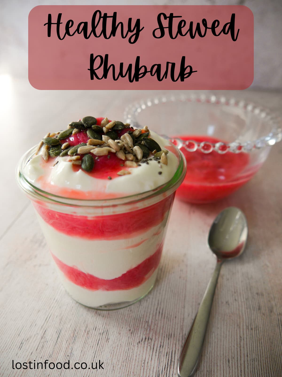 Pinnable image with recipe title and a glass filled with Greek yogurt layered with stewed rhubarb and topped with pumpkin, sunflower and chia seeds, with a bowl of healthy stewed rhubarb set alongside.