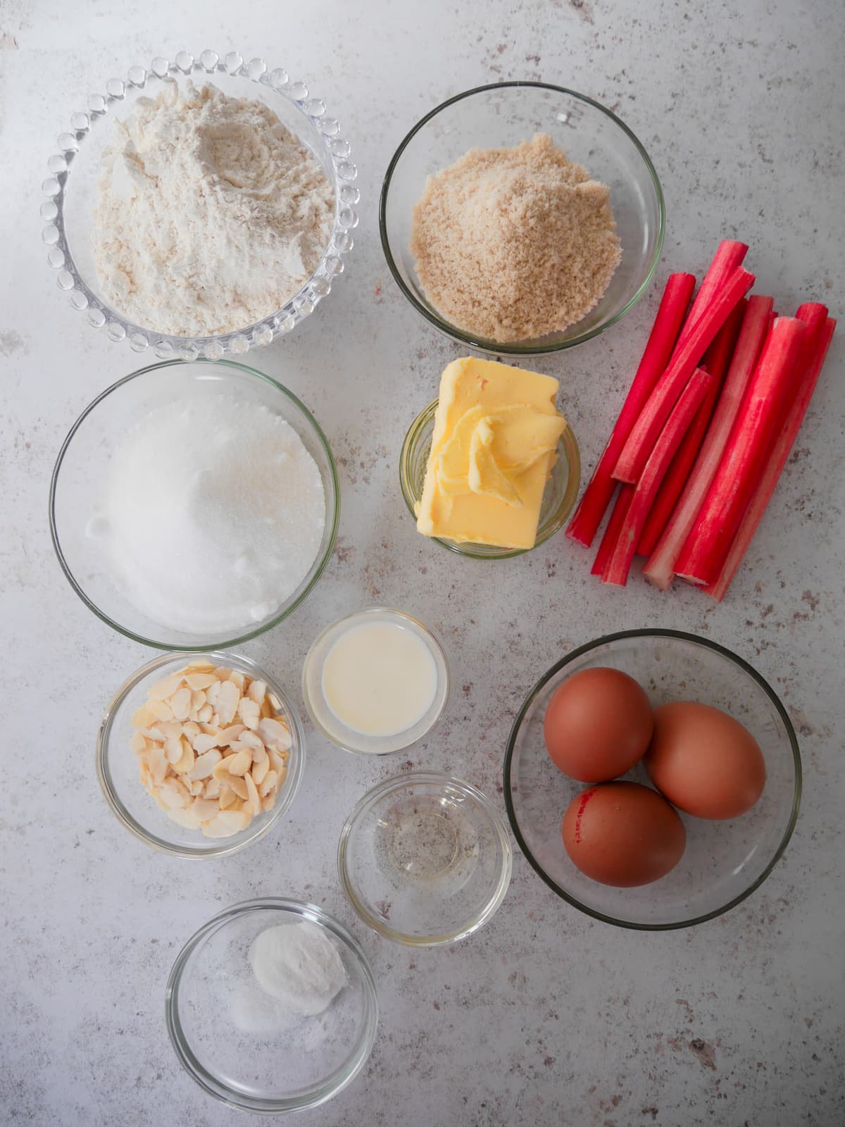 Individual recipe ingredients for rhubarb and almond loaf cake.