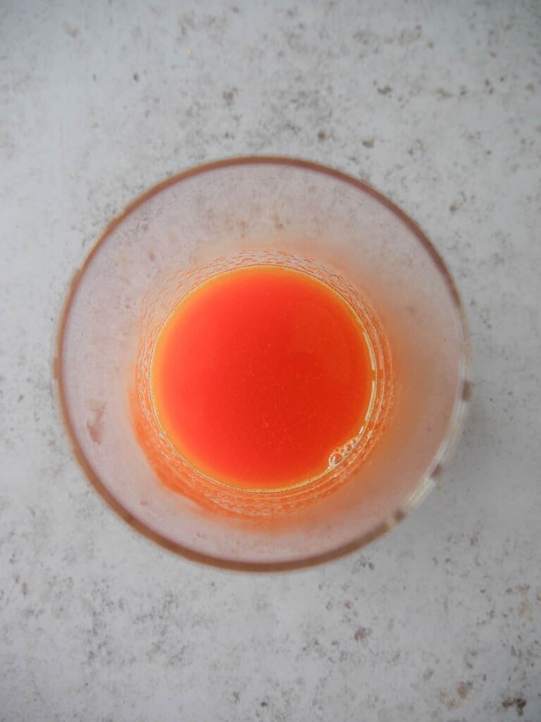 A glass of rhubarb and orange juice.