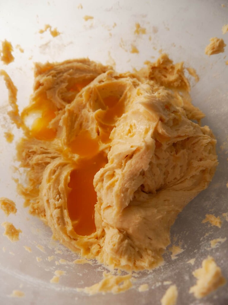 A bowl of cake batter with added fresh orange juice.