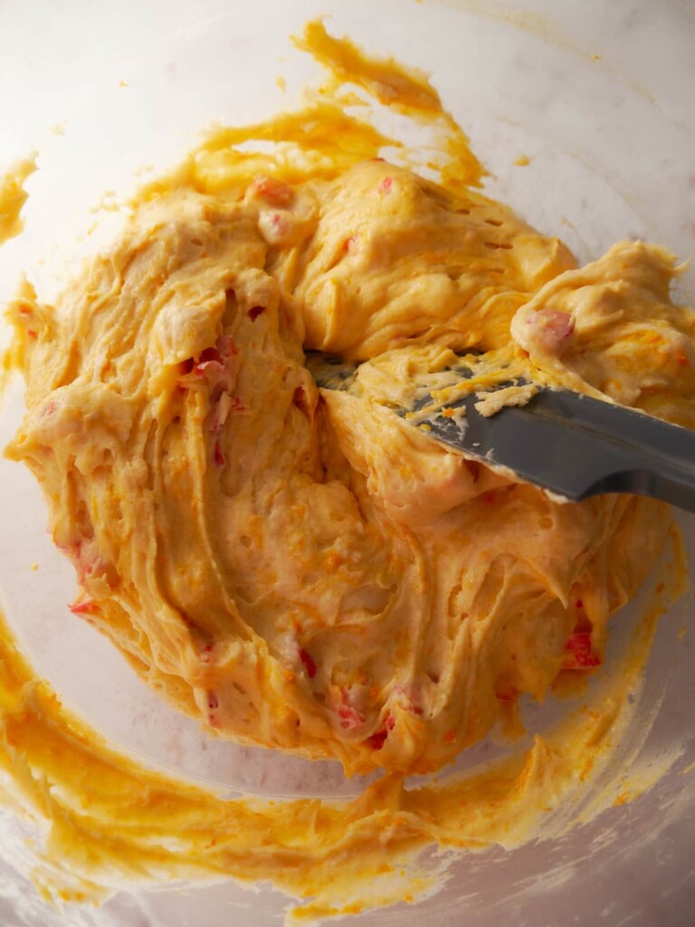 A bowl of rhubarb and orange cake batter.