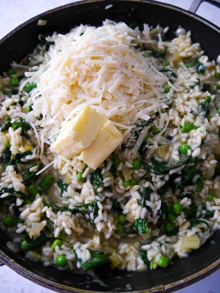 Spring vegetable risotto with added butter and freshly grated Parmesan cheese.