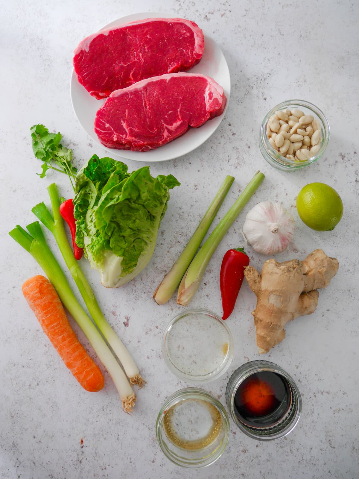 Individual ingredients for steak cooked in lemongrass marinade.