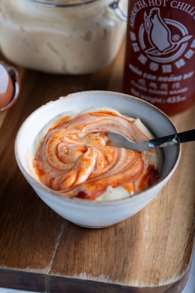 A bowl of homemade mayonnaise with added sriracha sauce.