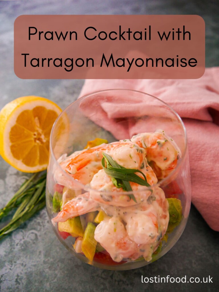 Pinnable image with recipe title and a large glass filled with a base of shredded lettuce, chopped tomato and avocado, topped with king prawns in a tarragon mayonnaise, garnished with fresh tarragon.