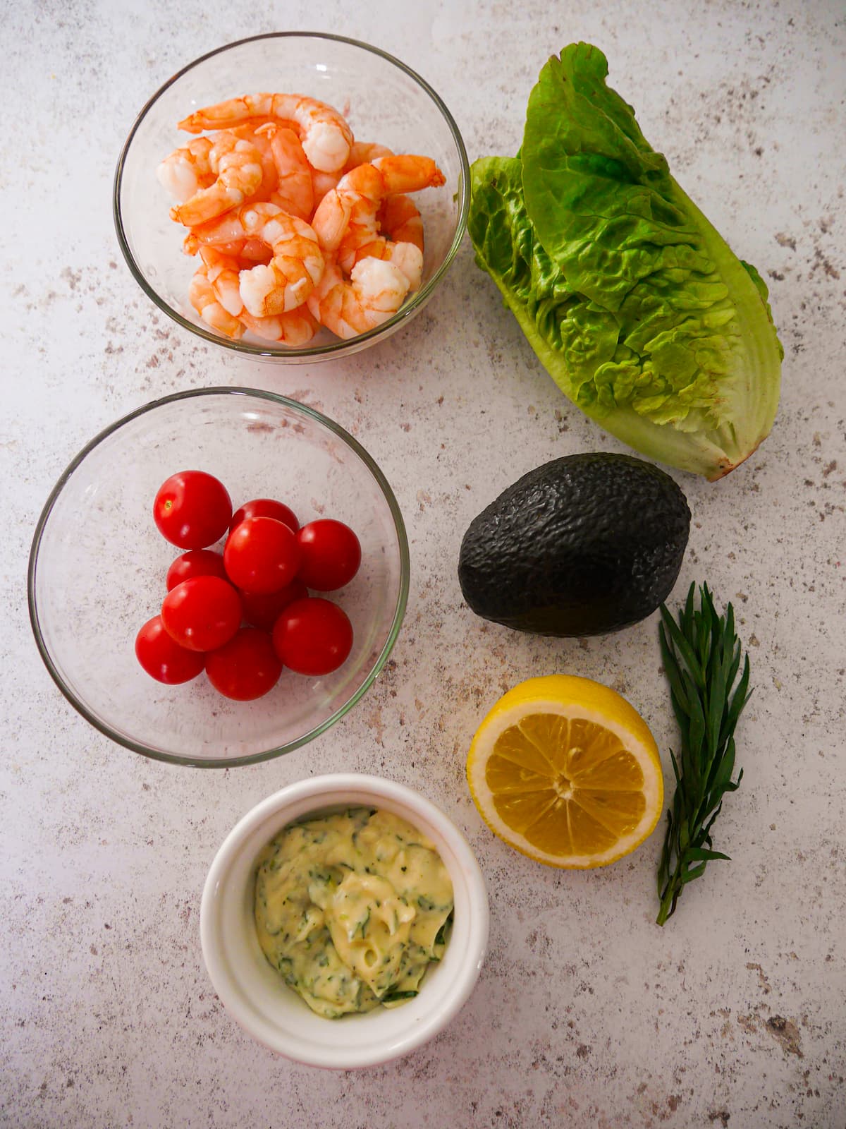 Individual recipe ingredients for cooked king prawns in a tarragon mayonnaise.