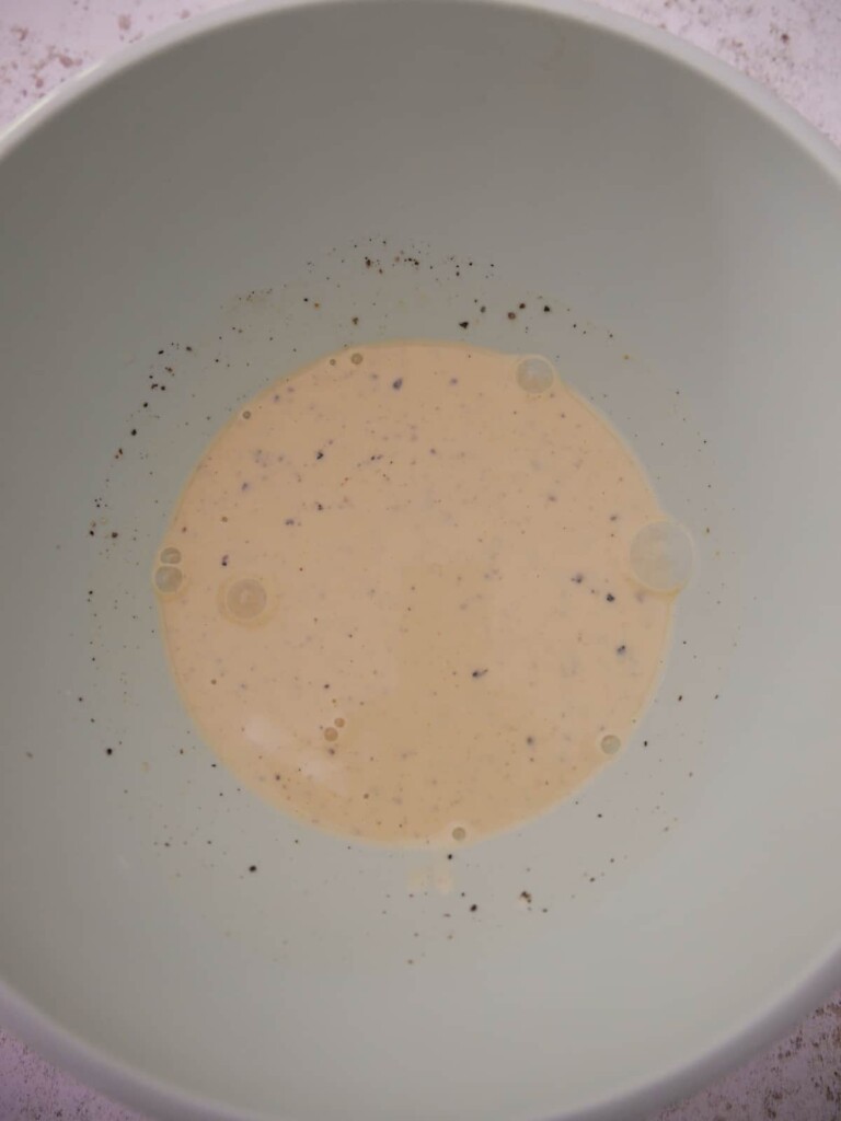 A bowl with celeriac remoulade salad dressing.