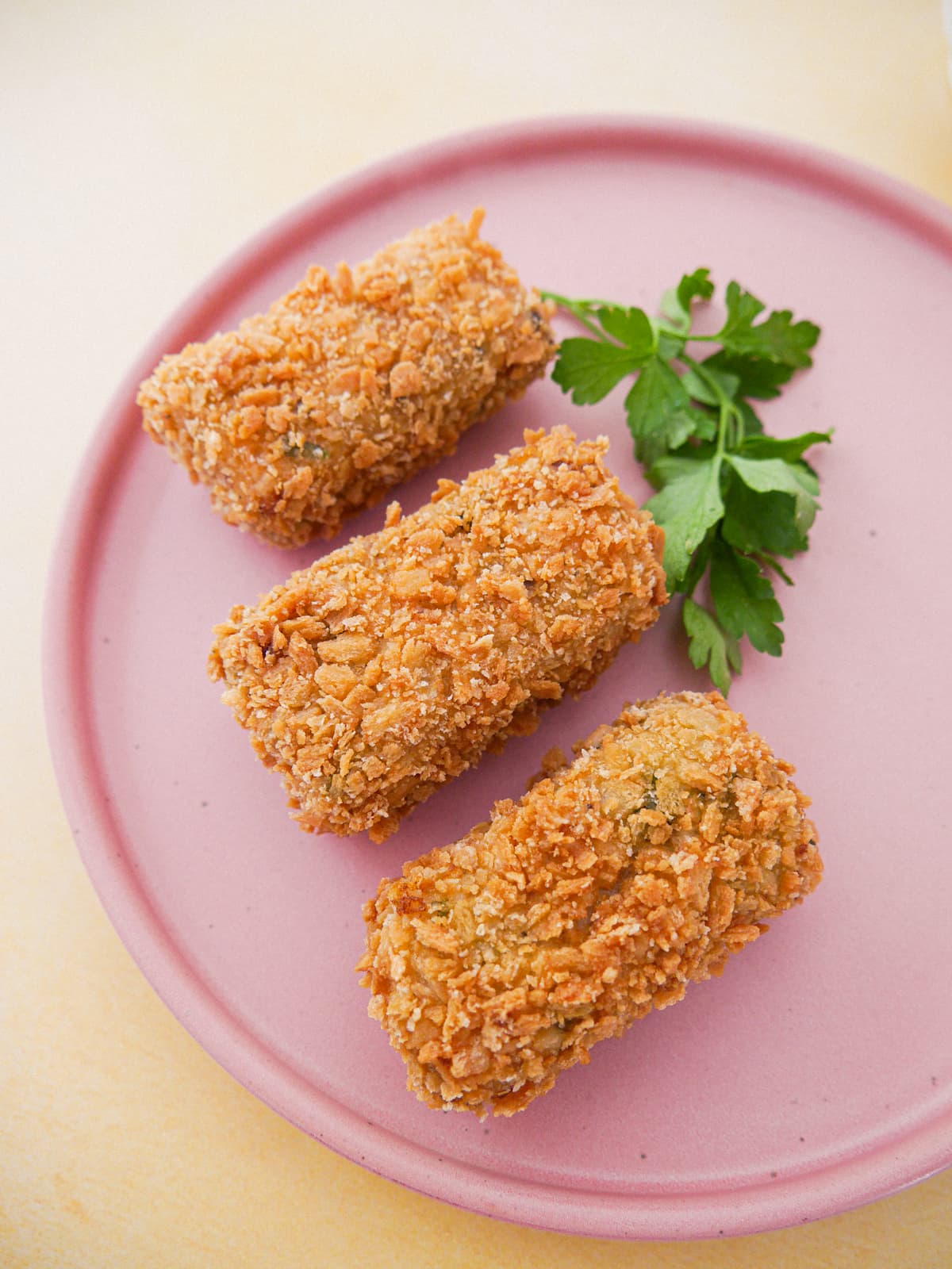 A plate with 3 Spanish chorizo chicken croquettes.
