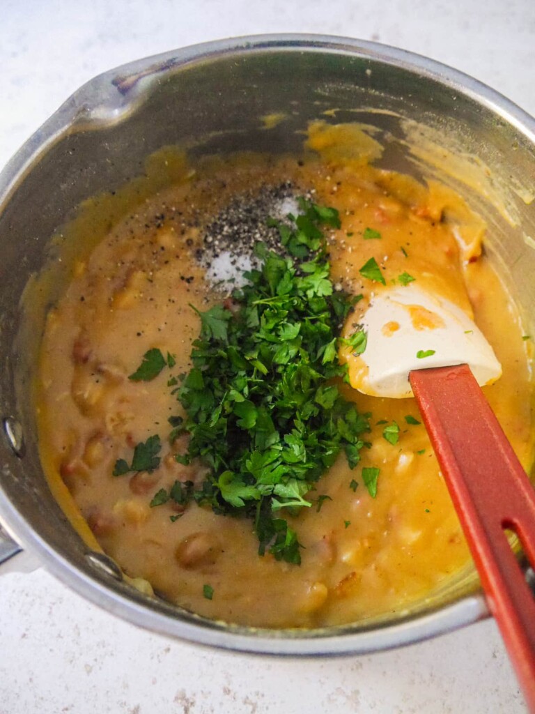 A thick white sauce, flavored with chorizo, chicken and onion with added chopped parsley, sea salt and black pepper.
