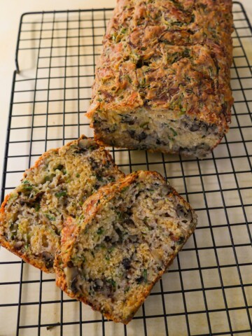 Courgette & cheese bread with walnuts set on a wire cooling rack.
