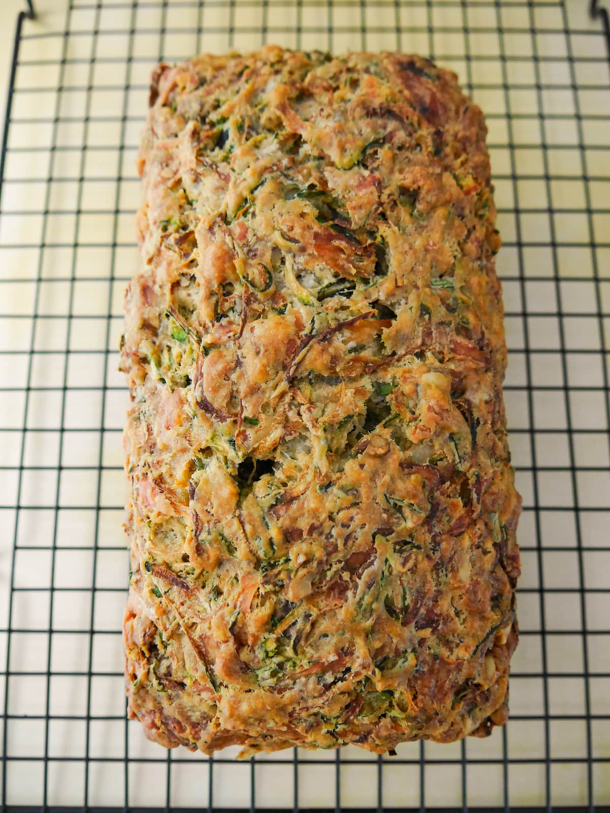Courgette and cheese bread set on a wire cooling rack.