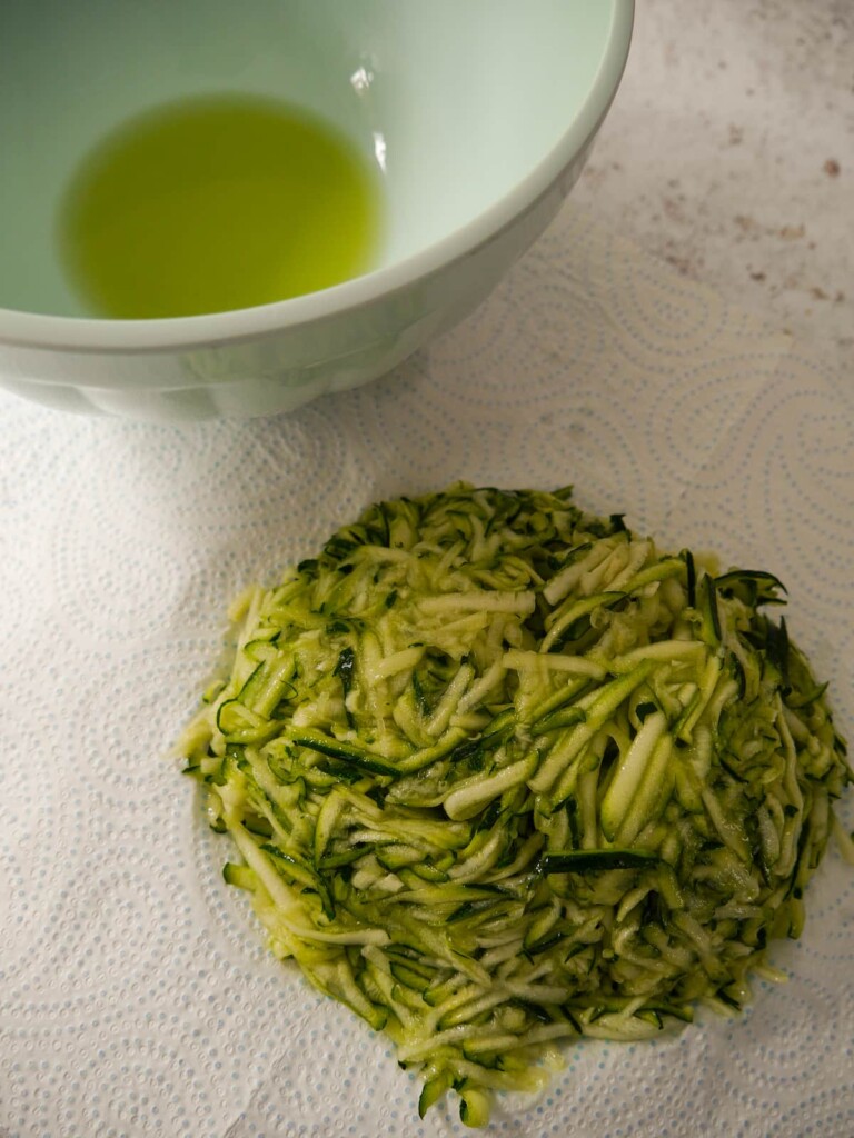 Salted and drained courgette on some kitchen roll.