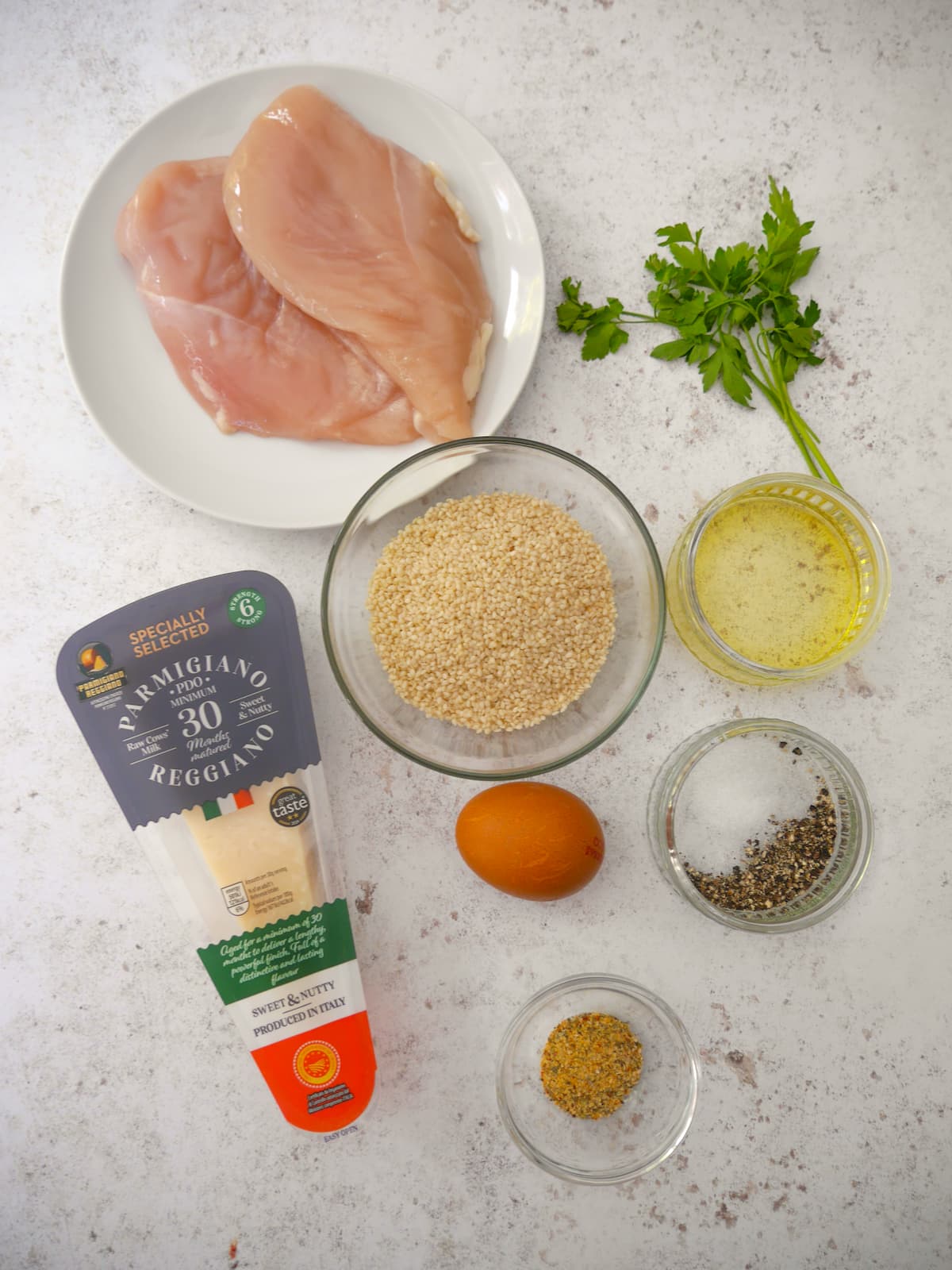 Individual recipe ingredients for sesame crusted chicken breast.