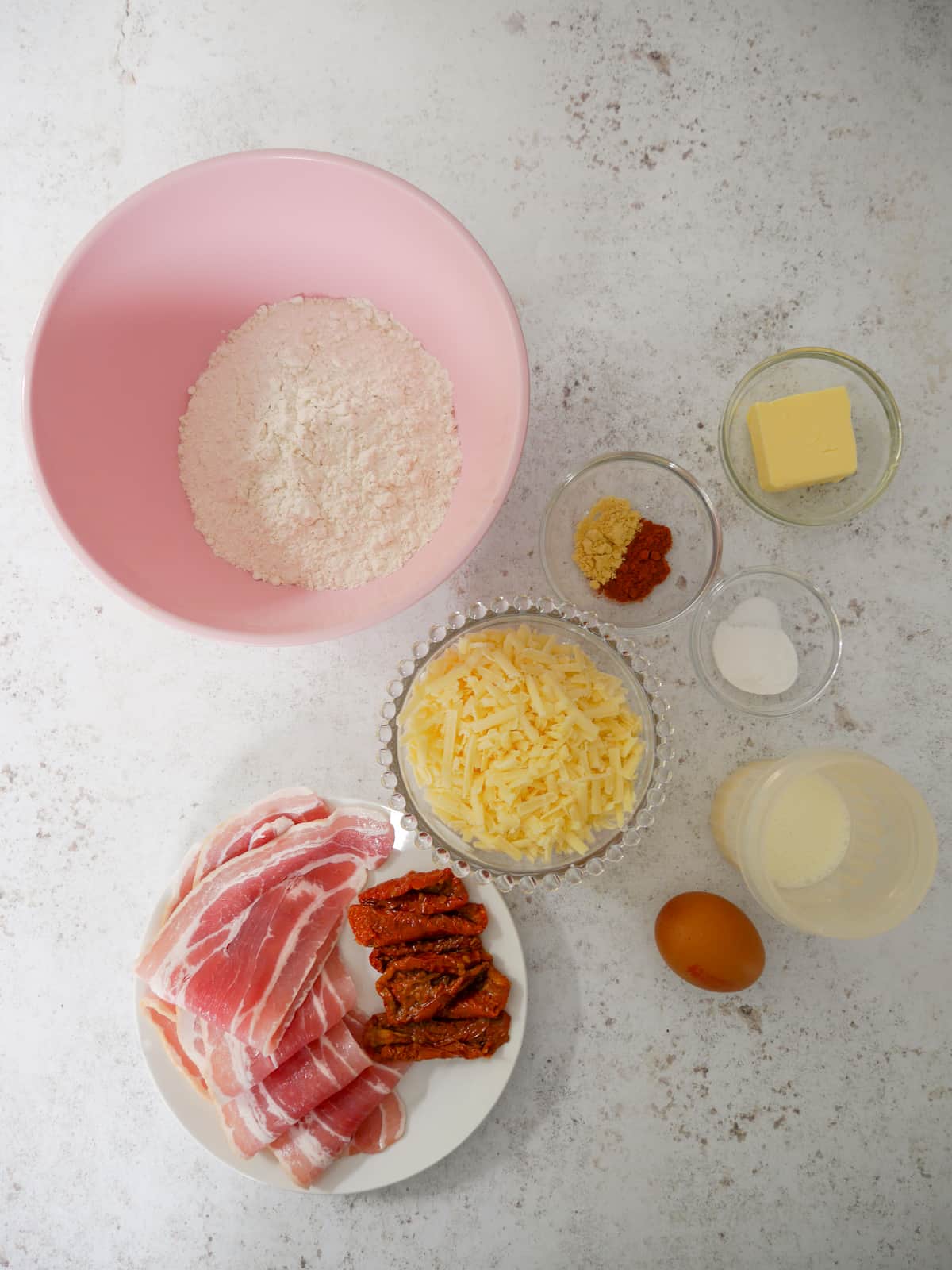 Individual recipe ingredients for cheese bacon and tomato scones.