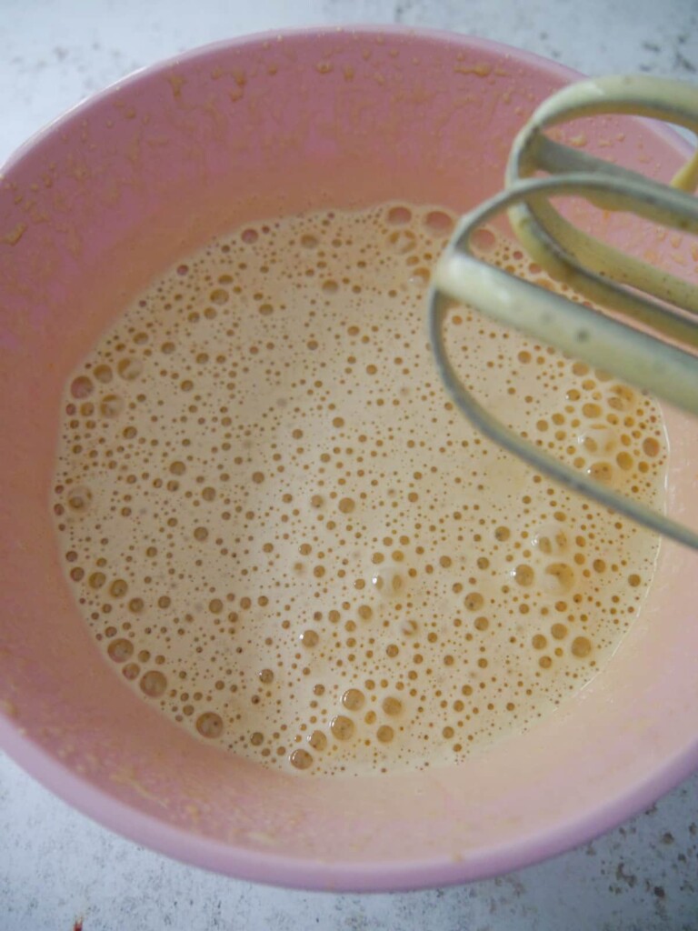 A bowl of whisked eggs and sugar.