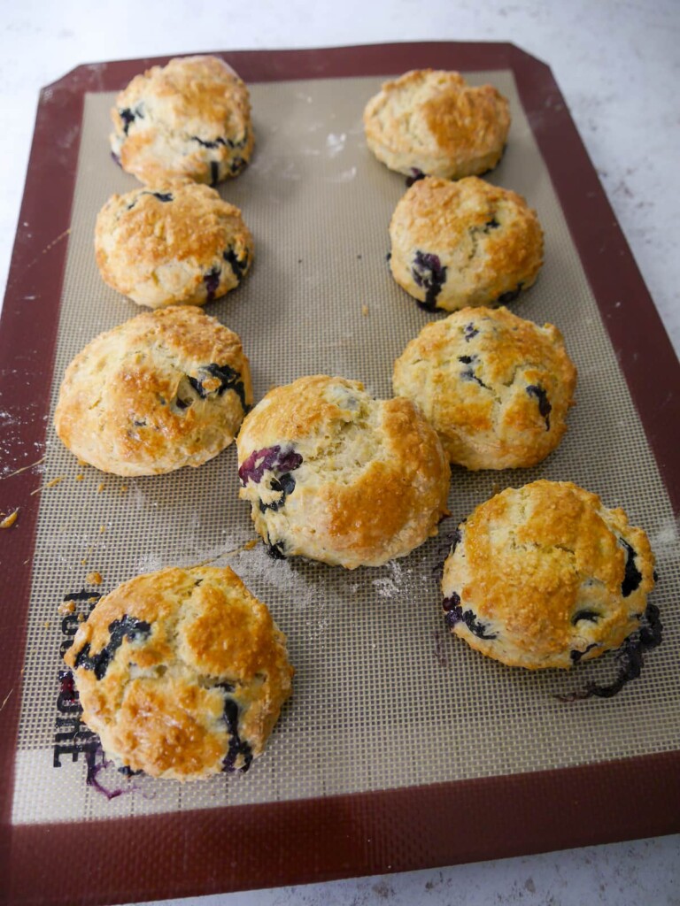 A baking sheet of freshly baked lemon and blueberry scones.