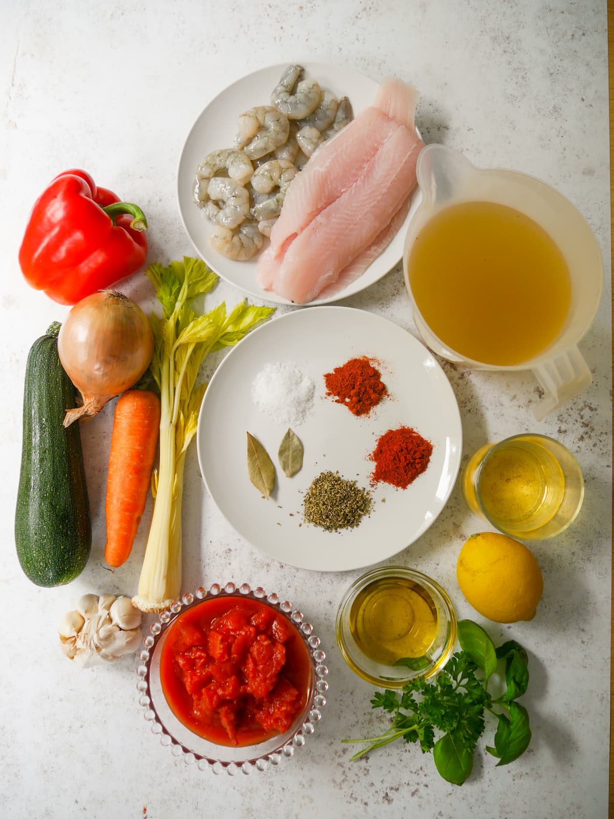 Individual recipe ingredients for making Mediterranean fish soup.