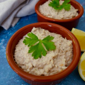 2 bowls of smoked mackerel pate with wedges of lemon set alongside.