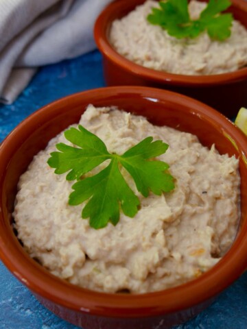 2 bowls of smoked mackerel pate with wedges of lemon set alongside.