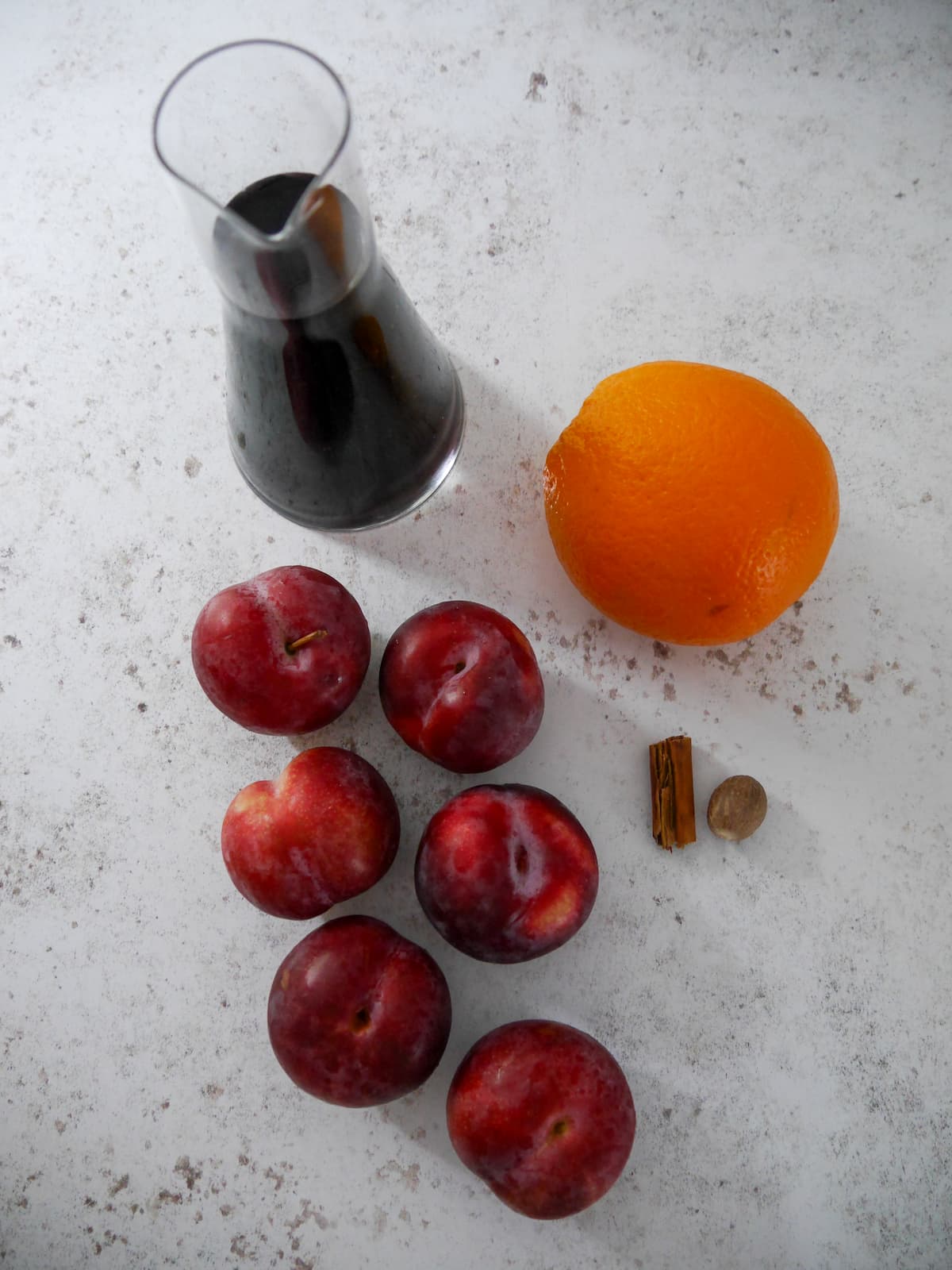 Individual recipe ingredients for mulled plums.
