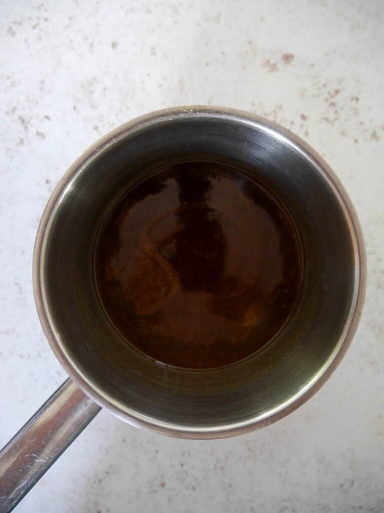 A saucepan of melted coconut oil and honey.