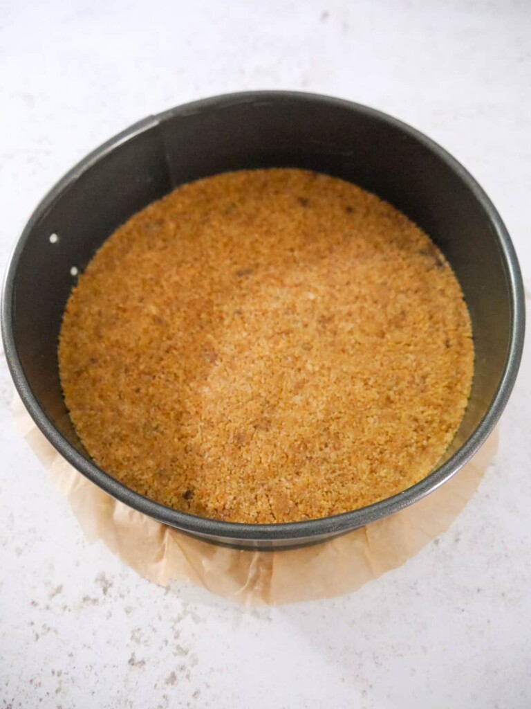 A baking tin with a biscuit base crumb.