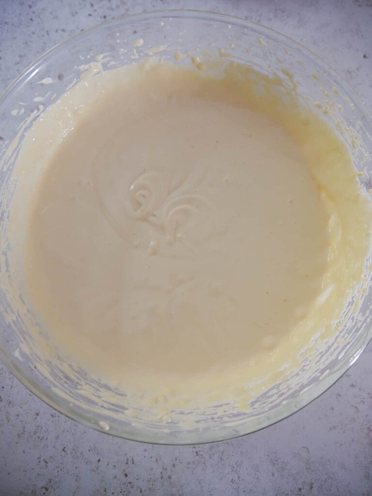 A large bowl of vanilla cheesecake mixture.