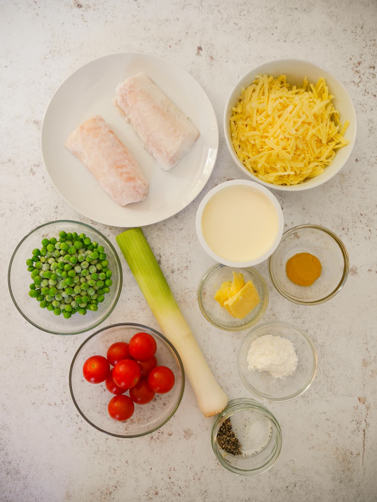 Individual recipe ingredients for making fish gratin.