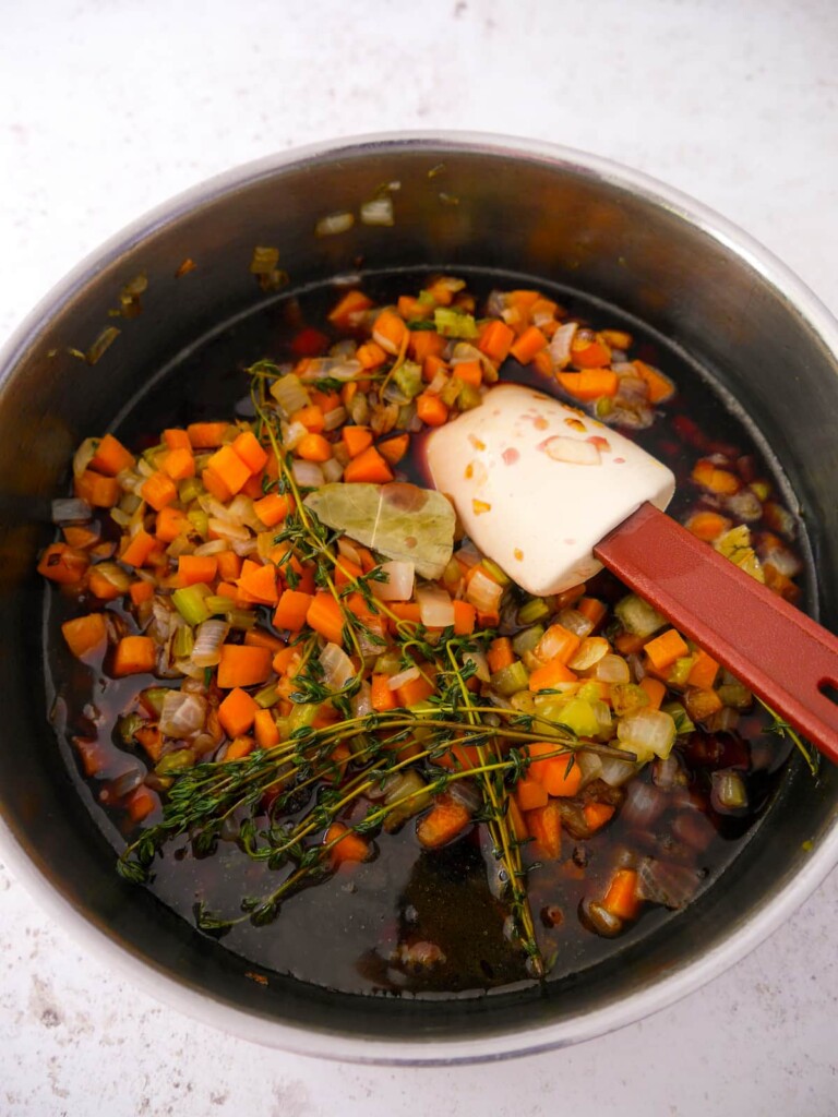 Vegan gravy base vegetables and herbs with added red wine.