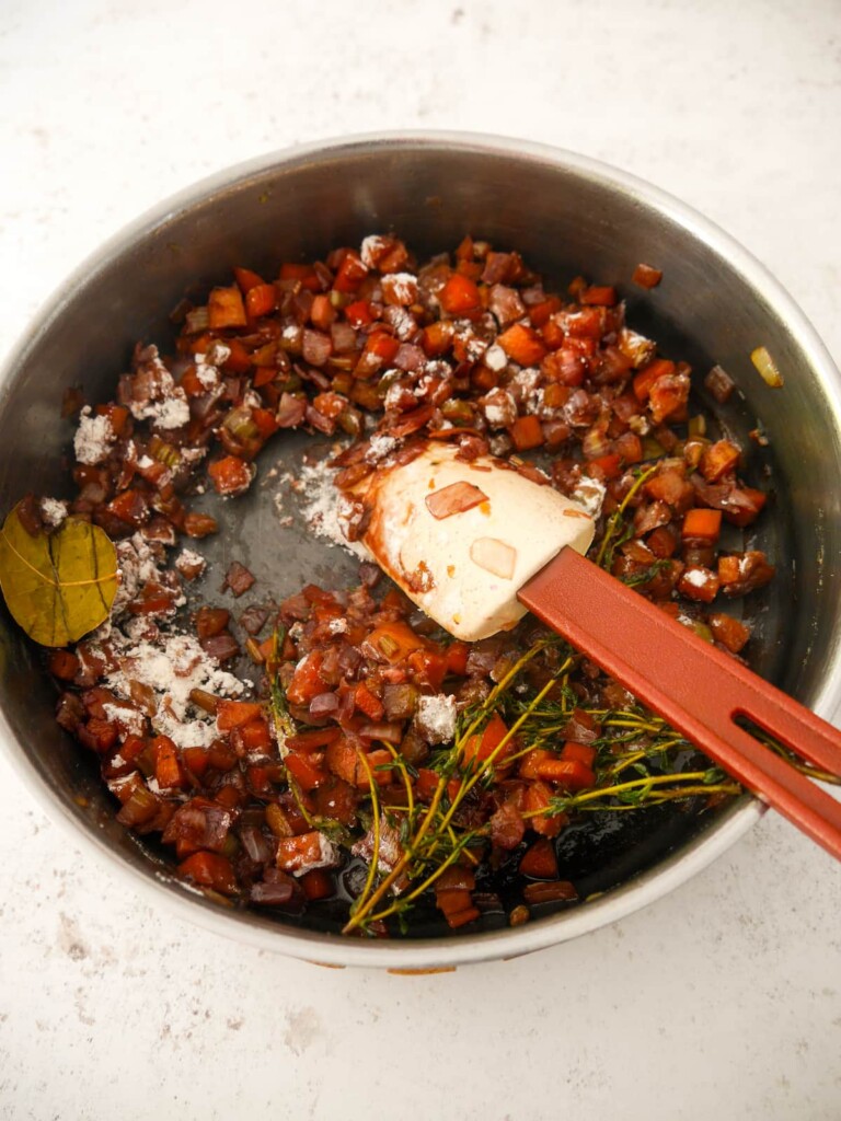 Vegan gravy base vegetables with added flour being stirred through.