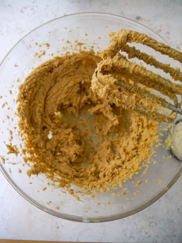A bowl of whisked butter and brown sugar.
