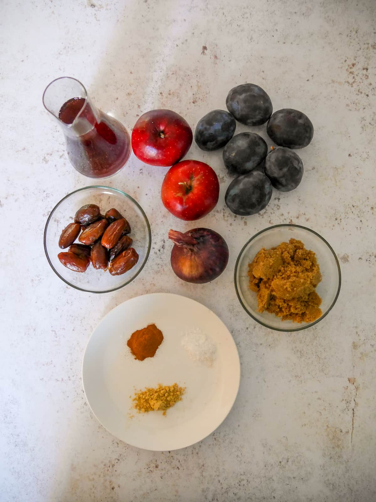 Individual recipe ingredients for making plum chutney.