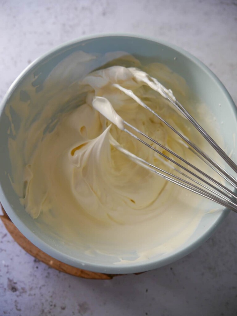 A bowl of softly whipped double cream (heavy cream).