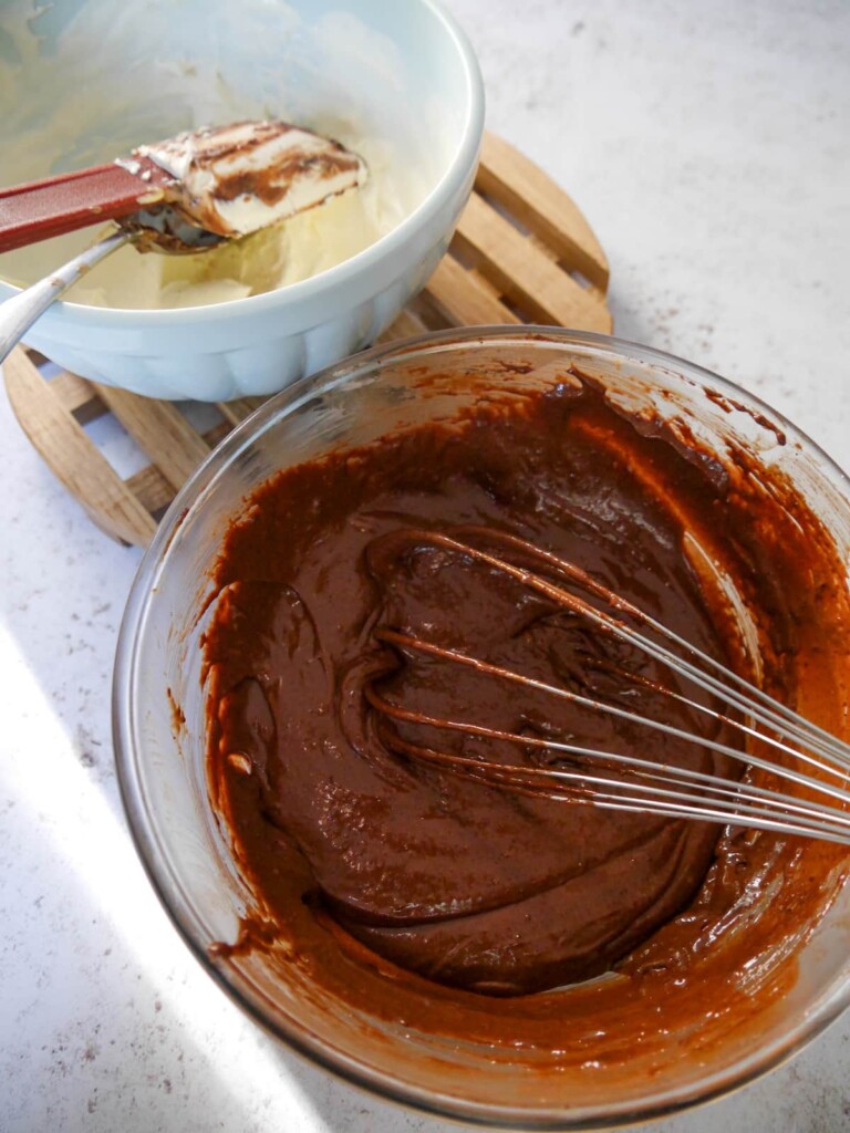 A bowl of of chocolate parfait mixture with the whipped double cream (heavy cream) being folded in.