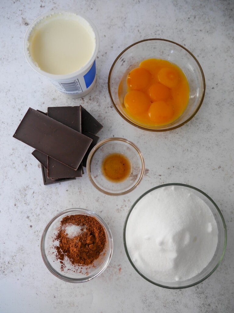 Individual recipe ingredients for making dark chocolate parfait.